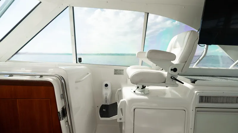 Life Of Reilly 2.0 Yacht Photos Pics Helm area of 2012 Cabo 44 HTX yacht with white captain's chair and ocean view.
