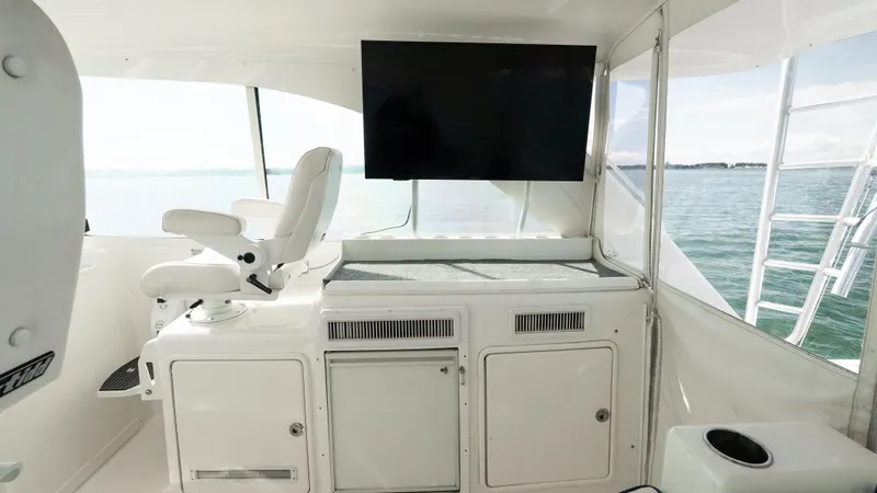 Life Of Reilly 2.0 Yacht Photos Pics Interior of 2012 Cabo 44 HTX yacht with helm seat and large screen.