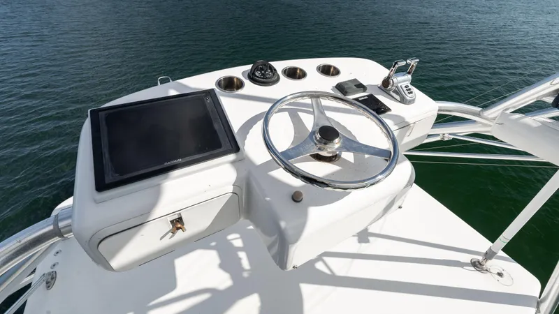 Life Of Reilly 2.0 Yacht Photos Pics Helm of 2012 Cabo 44 HTX yacht with steering wheel and navigation equipment.
