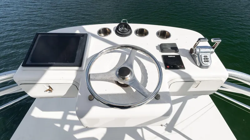 Life Of Reilly 2.0 Yacht Photos Pics Helm of 2012 Cabo 44 HTX yacht with steering wheel and navigation controls.