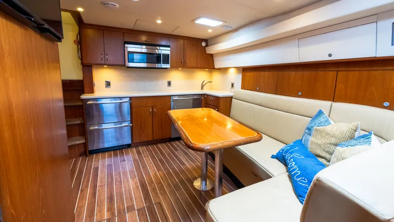 Life Of Reilly 2.0 Yacht Photos Pics Luxurious interior of 2012 Cabo 44 HTX yacht with modern kitchen and cozy seating area.