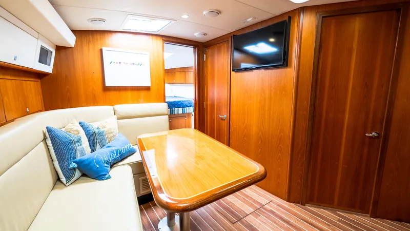 Life Of Reilly 2.0 Yacht Photos Pics Luxurious interior of 2012 Cabo 44 HTX yacht with wood paneling and cozy seating area.