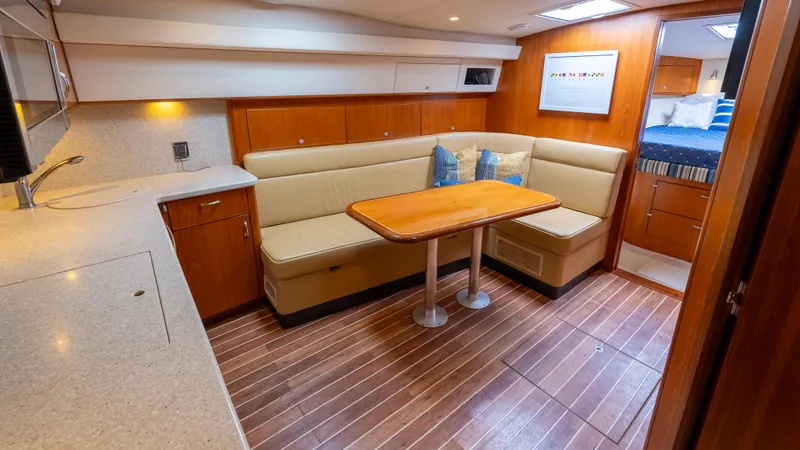 Life Of Reilly 2.0 Yacht Photos Pics Interior of 2012 Cabo 44 HTX yacht with cozy seating and wooden flooring.