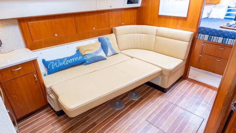 Life Of Reilly 2.0 Yacht Photos Pics Luxurious interior of 2012 Cabo 44 HTX yacht with beige seating and wooden flooring.