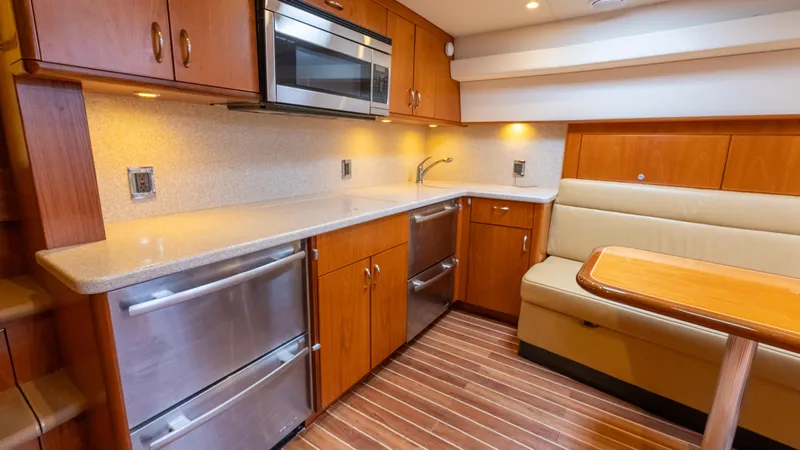 Life Of Reilly 2.0 Yacht Photos Pics Luxurious 2012 Cabo 44 HTX yacht interior with modern kitchen and dining area.
