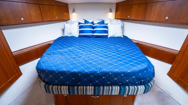 Life Of Reilly 2.0 Yacht Photos Pics Luxurious cabin interior of 2012 Cabo 44 HTX yacht with blue bedding.