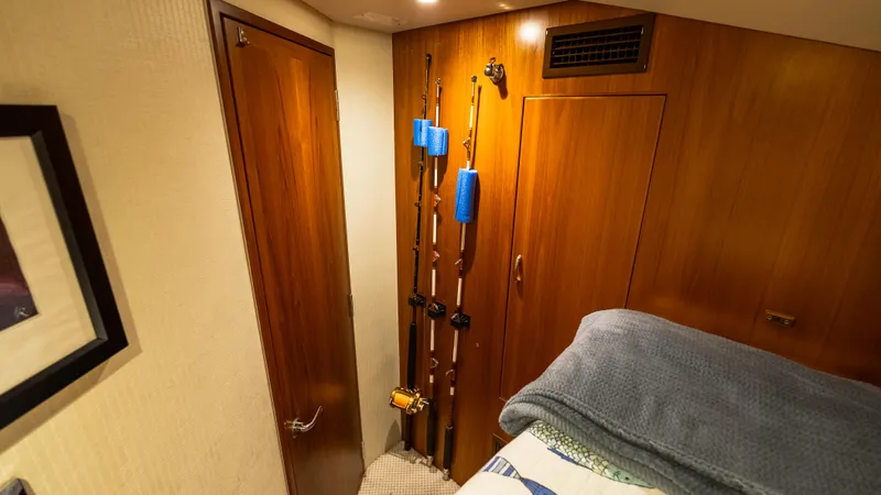 Life Of Reilly 2.0 Yacht Photos Pics Interior of 2012 Cabo 44 HTX yacht with fishing rods and wooden cabinetry.
