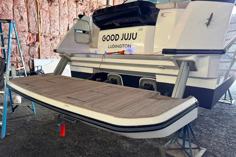  Yacht Photos Pics 2016 Beneteau Gran Turismo 40 yacht in storage, featuring "Good Juju" name and swim platform.