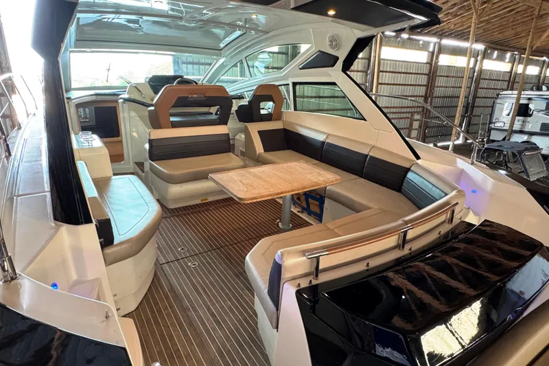  Yacht Photos Pics 2016 Beneteau Gran Turismo 40 yacht interior with seating and table in a covered dock.