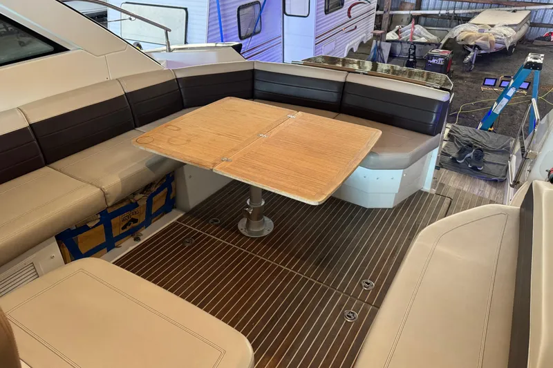  Yacht Photos Pics Interior of 2016 Beneteau Gran Turismo 40 yacht with seating and wooden table.