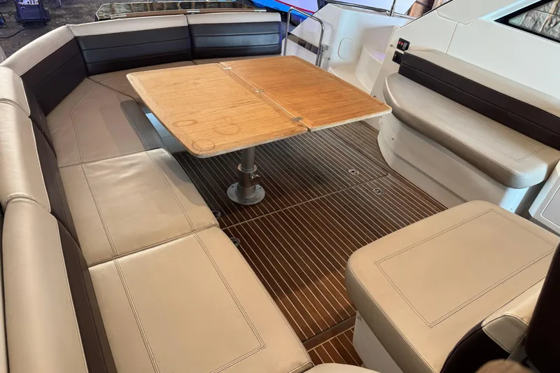  Yacht Photos Pics 2016 Beneteau Gran Turismo 40 interior with beige seating and wooden table.