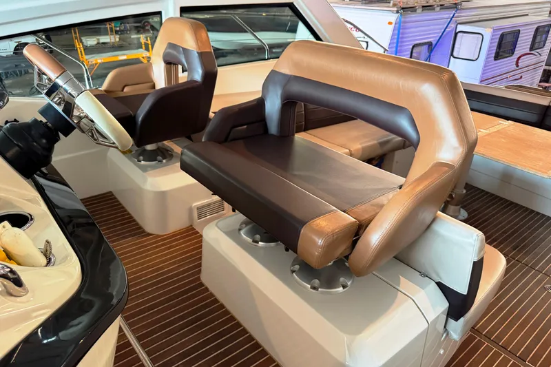 Yacht Photos Pics Captain's seat on 2016 Beneteau Gran Turismo 40 yacht, featuring luxurious leather upholstery.