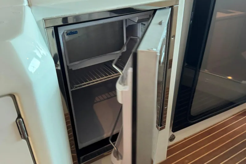  Yacht Photos Pics Open refrigerator on 2016 Beneteau Gran Turismo 40 yacht, showcasing interior shelves.