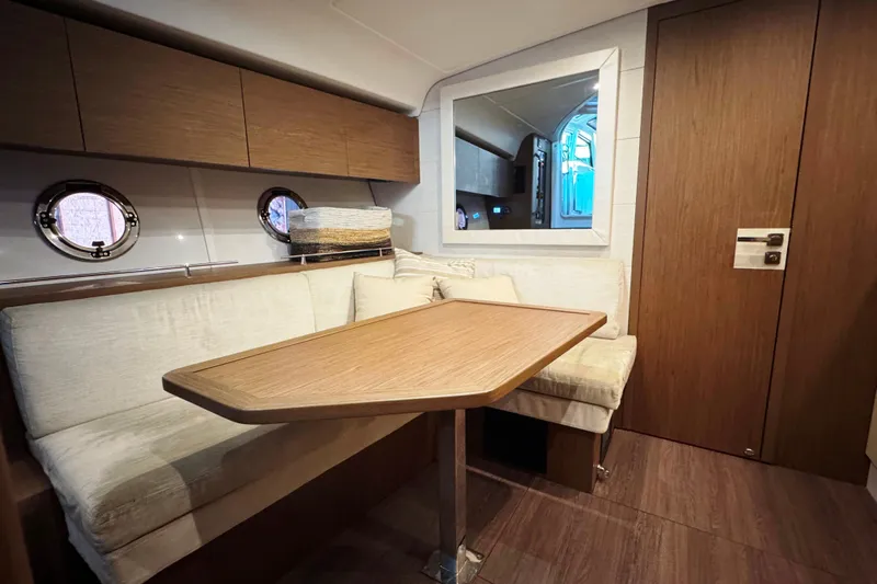  Yacht Photos Pics Interior of 2016 Beneteau Gran Turismo 40 yacht with cozy seating and wooden table.
