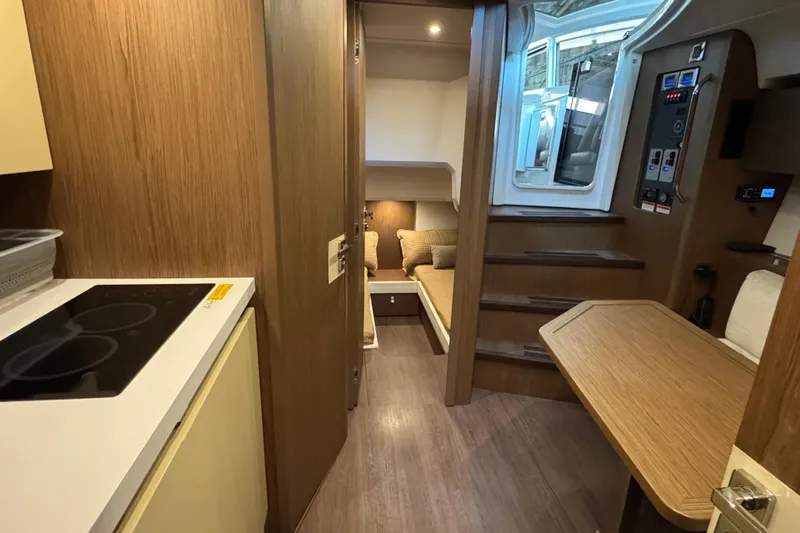  Yacht Photos Pics Interior of 2016 Beneteau Gran Turismo 40 yacht, featuring modern wood finishes and cozy seating.