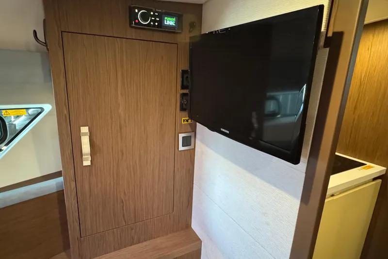  Yacht Photos Pics Interior of 2016 Beneteau Gran Turismo 40 with TV and wooden cabinetry.