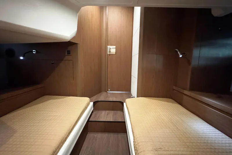  Yacht Photos Pics Interior cabin of 2016 Beneteau Gran Turismo 40 with twin beds and wooden finish.