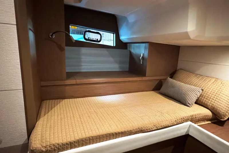  Yacht Photos Pics Cozy cabin interior of 2016 Beneteau Gran Turismo 40 yacht with comfortable bedding.