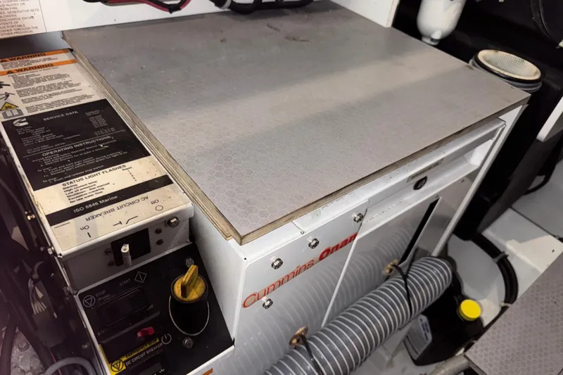  Yacht Photos Pics Cummins Onan generator in 2016 Beneteau Gran Turismo 40 engine room, showcasing controls and components.