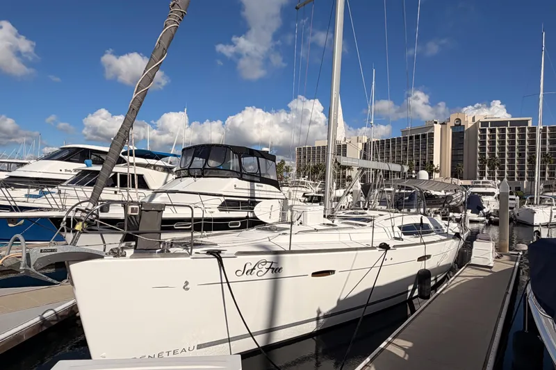 Set Free Yacht Photos Pics 2007 Beneteau 49 sailboat docked at marina under blue sky.