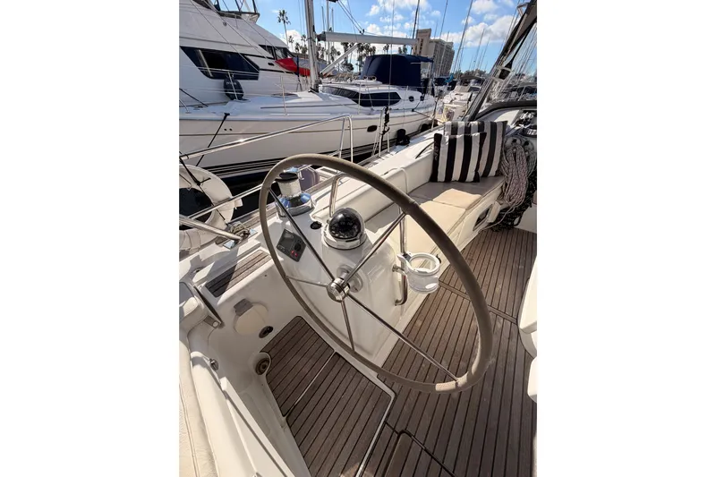 Set Free Yacht Photos Pics Steering wheel of a 2007 Beneteau 49 yacht, docked at a marina.