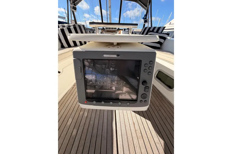 Set Free Yacht Photos Pics Navigation system on 2007 Beneteau 49 yacht, featuring striped seating and wooden deck.