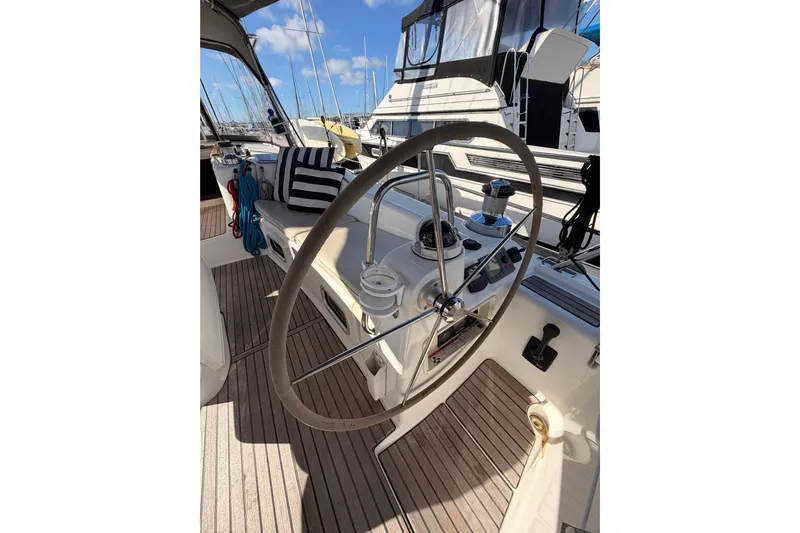 Set Free Yacht Photos Pics Cockpit of 2007 Beneteau 49 sailboat with steering wheel and nautical equipment.