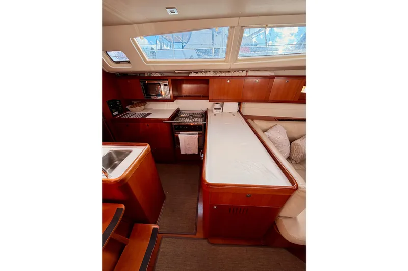 Set Free Yacht Photos Pics Interior of 2007 Beneteau 49 yacht with modern kitchen and seating area.
