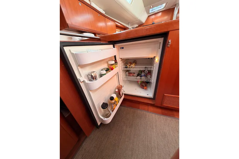 Set Free Yacht Photos Pics Open refrigerator in 2007 Beneteau 49 yacht kitchen, stocked with beverages and condiments.