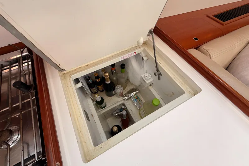 Set Free Yacht Photos Pics Built-in cooler with beverages on a 2007 Beneteau 49 yacht interior.