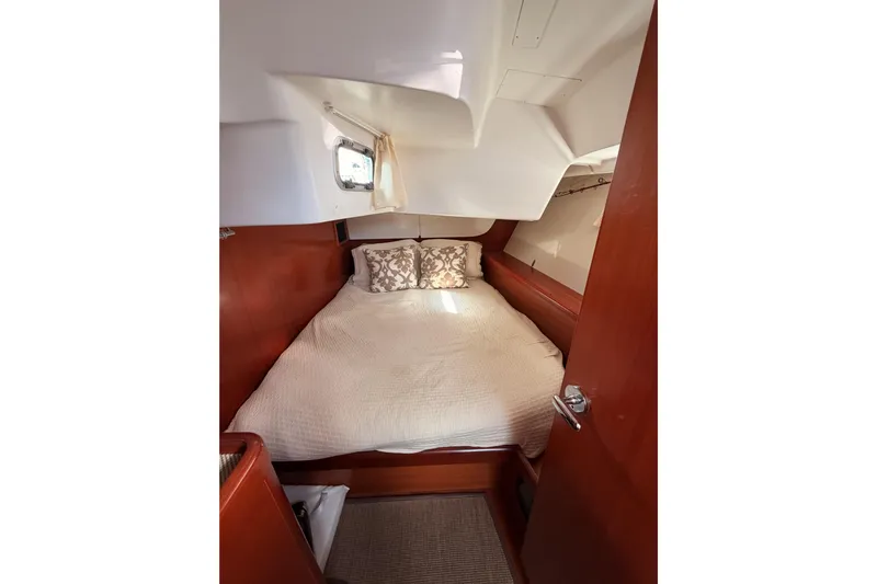 Set Free Yacht Photos Pics Cozy cabin interior of 2007 Beneteau 49 yacht with bed and porthole.