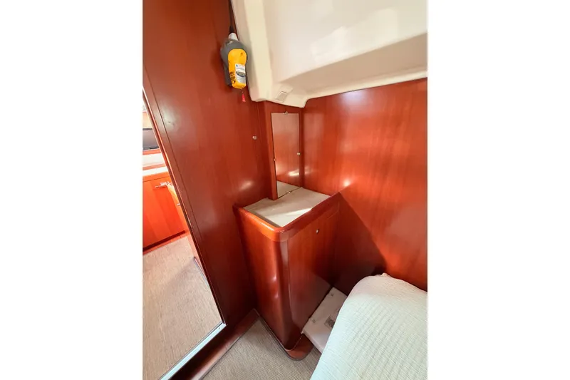 Set Free Yacht Photos Pics Interior of 2007 Beneteau 49 yacht with wooden cabinetry and cozy sleeping area.