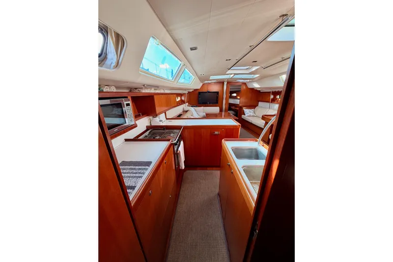 Set Free Yacht Photos Pics Luxurious interior of 2007 Beneteau 49 yacht with modern kitchen and seating area.