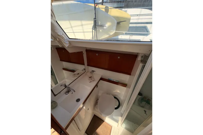 Set Free Yacht Photos Pics Bathroom interior of 2007 Beneteau 49 yacht with sink and toilet.