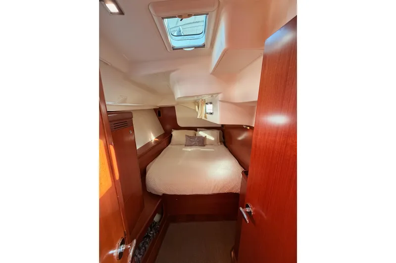 Set Free Yacht Photos Pics Cozy cabin interior of 2007 Beneteau 49 yacht with wooden finish and skylight.