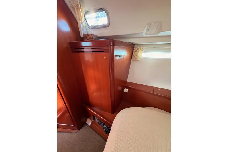 Set Free Yacht Photos Pics Interior cabin of 2007 Beneteau 49 yacht with wooden cabinetry and window.
