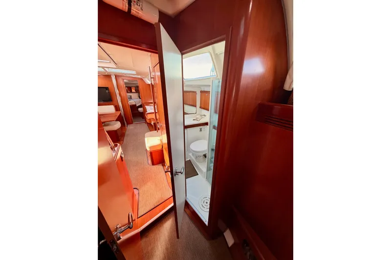 Set Free Yacht Photos Pics Interior of 2007 Beneteau 49 yacht, featuring wood finishes and a compact bathroom.
