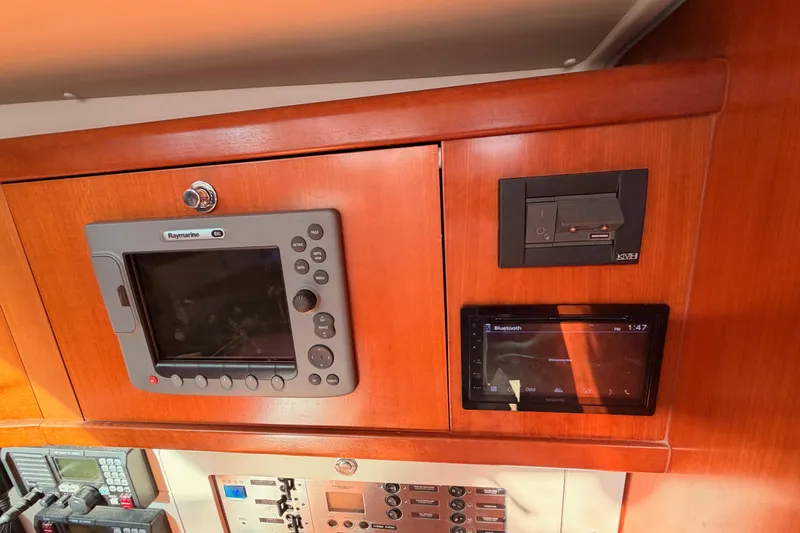 Set Free Yacht Photos Pics Control panel of a 2007 Beneteau 49 yacht with navigation and audio systems.