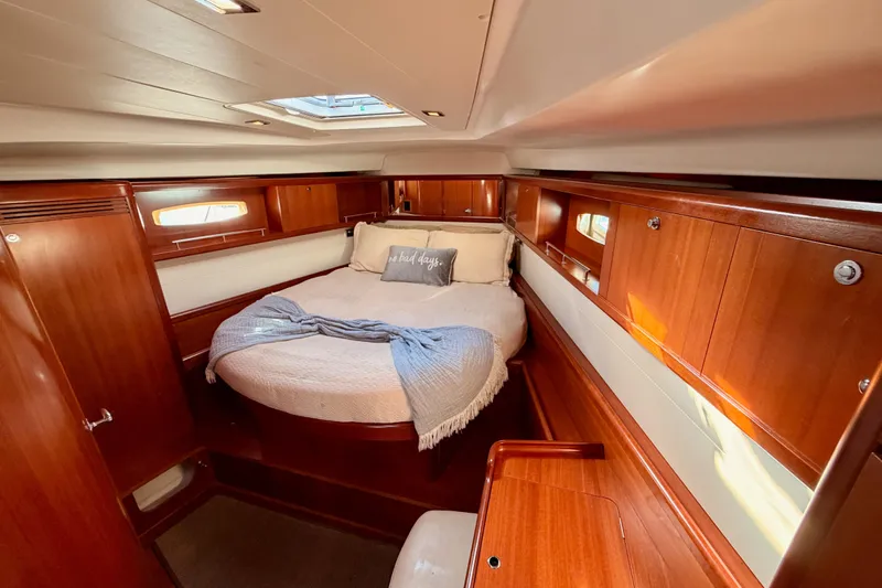 Set Free Yacht Photos Pics Luxurious 2007 Beneteau 49 yacht cabin with cozy bed and elegant wood finish.