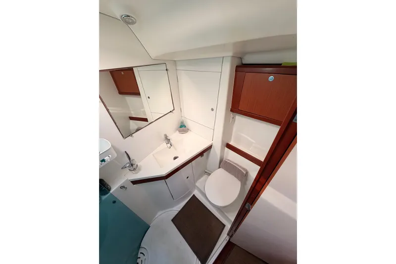 Set Free Yacht Photos Pics 2007 Beneteau 49 yacht bathroom with modern fixtures and wood accents.