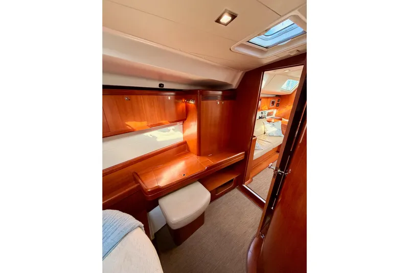 Set Free Yacht Photos Pics Luxurious interior of 2007 Beneteau 49 yacht with wooden finish and cozy cabin.