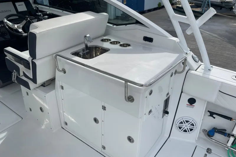  Yacht Photos Pics 2022 Blackfin 272 DC boat interior with sink and seating area.