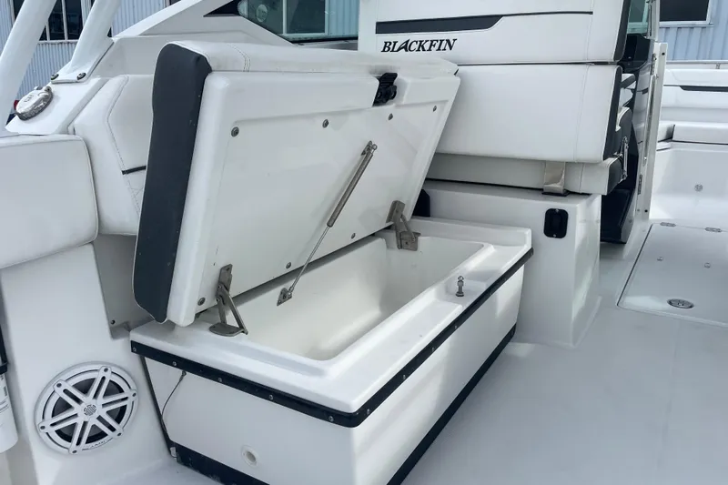  Yacht Photos Pics 2022 Blackfin 272 DC boat with open storage compartment and sleek white interior design.
