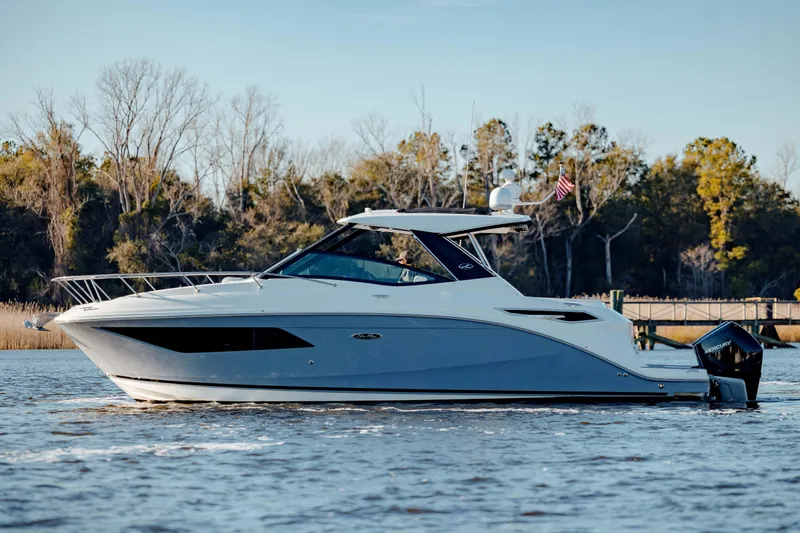  Yacht Photos Pics 2019 Sea Ray 320 Sundancer OB cruising on a calm lake.
