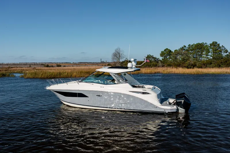  Yacht Photos Pics 2019 Sea Ray 320 Sundancer OB cruising on a calm river.