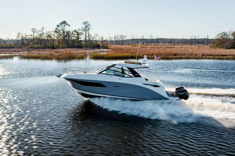  Yacht Photos Pics 2019 Sea Ray 320 Sundancer OB cruising on a calm lake.