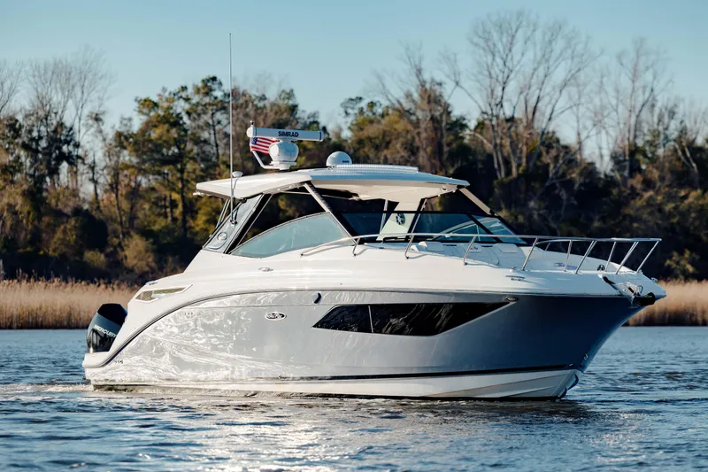  Yacht Photos Pics 2019 Sea Ray 320 Sundancer OB cruising on a calm lake.