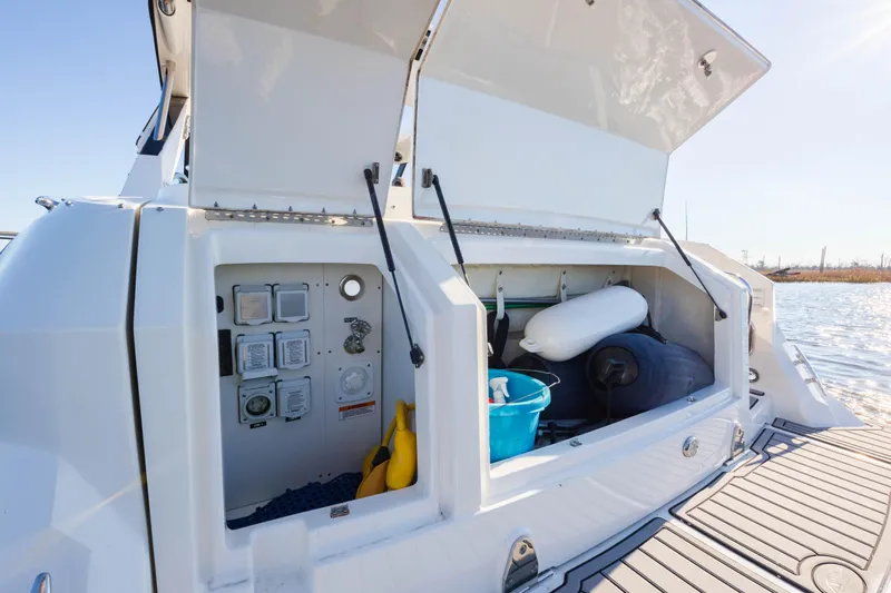  Yacht Photos Pics 2019 Sea Ray 320 Sundancer OB storage compartment with open hatches, dockside view.