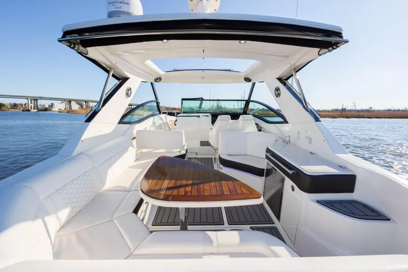  Yacht Photos Pics 2019 Sea Ray 320 Sundancer OB luxury boat interior with white seating and wooden table.