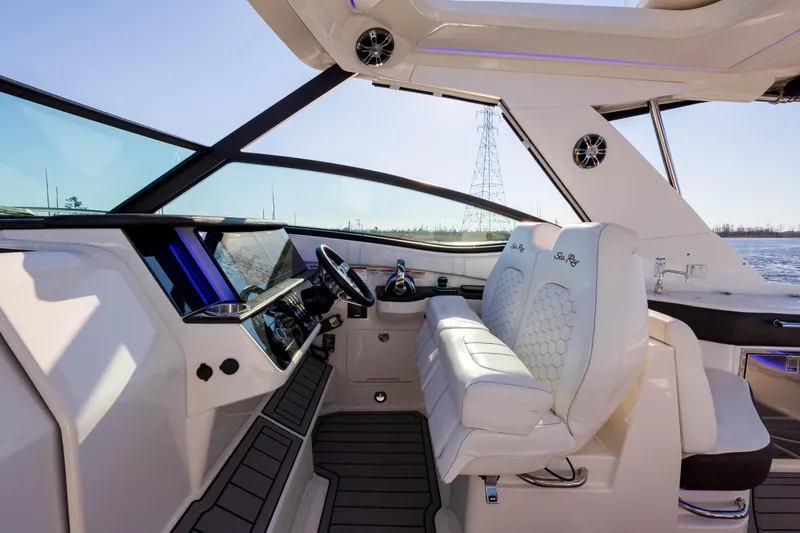  Yacht Photos Pics Interior helm of 2019 Sea Ray 320 Sundancer OB with white leather seats and modern controls.